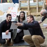 From left Jason Vafiades ’17 (ENG), Phoebe Szarek ’17 (ENG), and  Emil Atz ’17 (ENG) take a selfie with the time capsule. Also shown (wearing an orange shirt) is Peter Glaude, senior machine shop engineer. (Christopher LaRosa/UConn Photo)