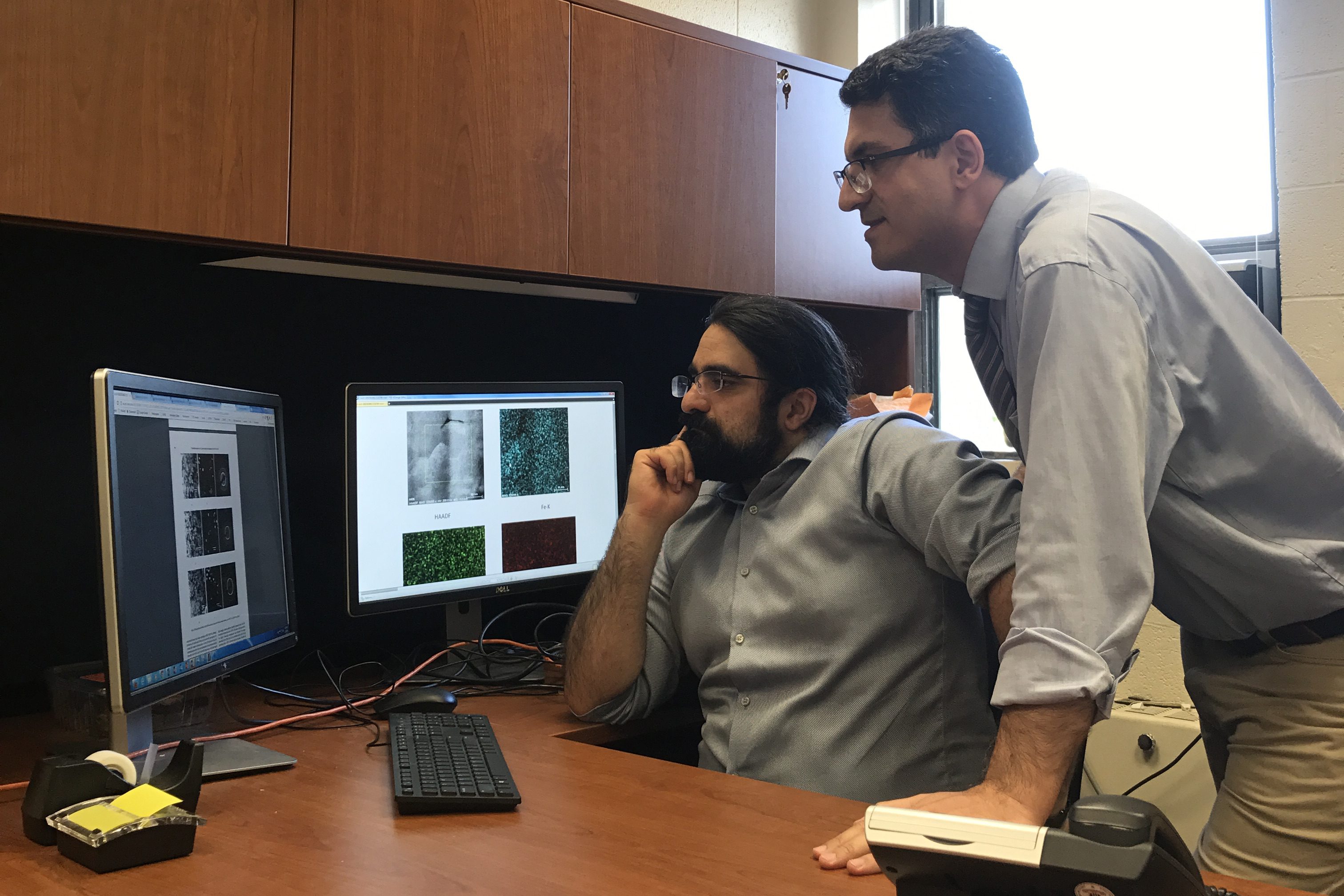 Postdoctoral researcher Peiman Shahbeigi (standing) and Sina Shahbazmohmadi, assistant professor in biomaterials engineering, discuss grain microstructures characterized by an advanced electron microscope.