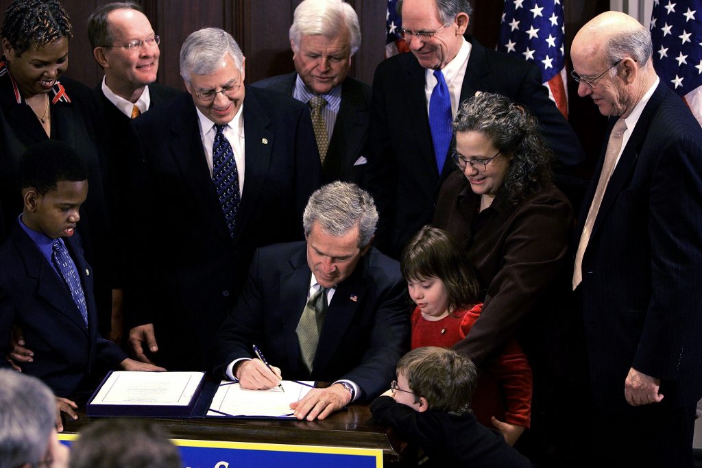 President George W. Bush signs the Individuals with Disabilities Education Improvement Act of 2004. (Getty Images)