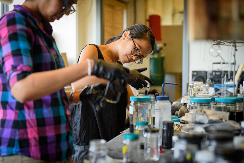 Chan Vy, right, a graduate student in materials science, and Chinthani Liyanage, a graduate student in chemistry, work with graphene in the lab at the Institute of Materials Science on Aug. 23, 2017. (Peter Morenus/UConn Photo)