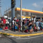 Crowds of people wait in line for gas at a Shell station in San Juan Puerto Rico on Sept. 26, 2017 after Hurricane Maria struck the island six days prior. International Medical Corps is in Puerto Rico to assess the damage and help those suffering in the wake of the storm. (Photo by Ken Cedeno, IMC)