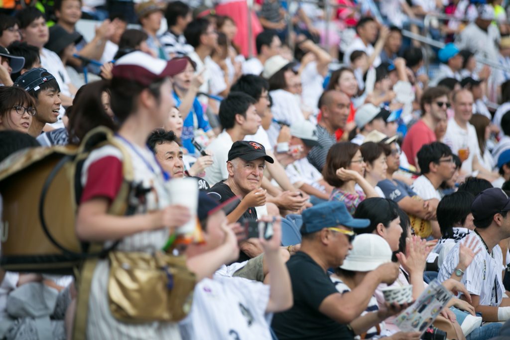 Human development and family studies professor Steven Wisensale, center, watches a baseball game at Chiba Marine Stadium near Tokyo. He spent the spring semester in Japan as a Fulbright Scholar. (Chris Moore for UConn)