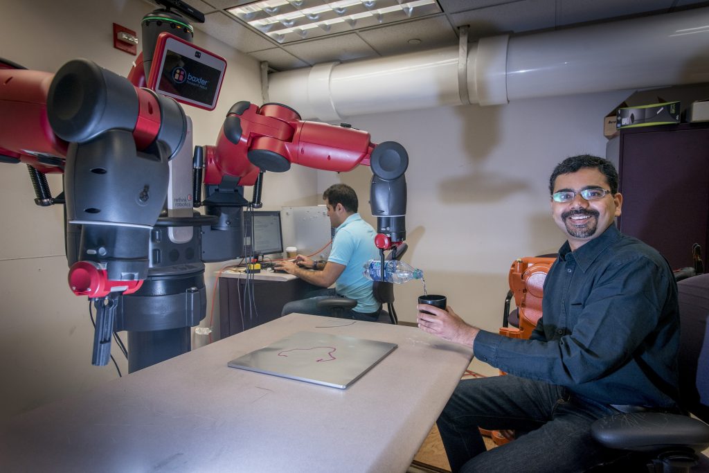 Ashwin Dani, assistant professor of electrical and computer engineering, is developing algorithms and software for robotic manipulation, to improve robots' interaction with humans. (Sean Flynn/UConn Photo)