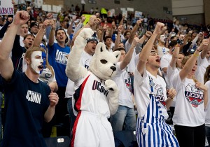 <p>Jonathan the Husky Dog cheers with student fans from the seats as the first ESPN College GameDay show for a women's basketball game was broadcast from Gampel Pavilion. Photo by Peter Morenus</p>