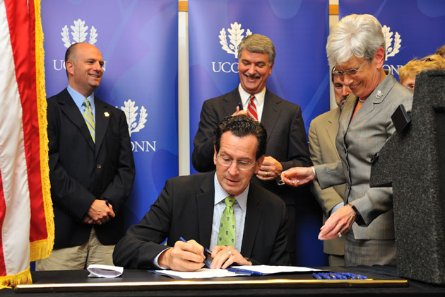Gov. Dannel P. Malloy signs legislation to build a technology park at UConn, during a ceremony held at the Advanced Technology Laboratory