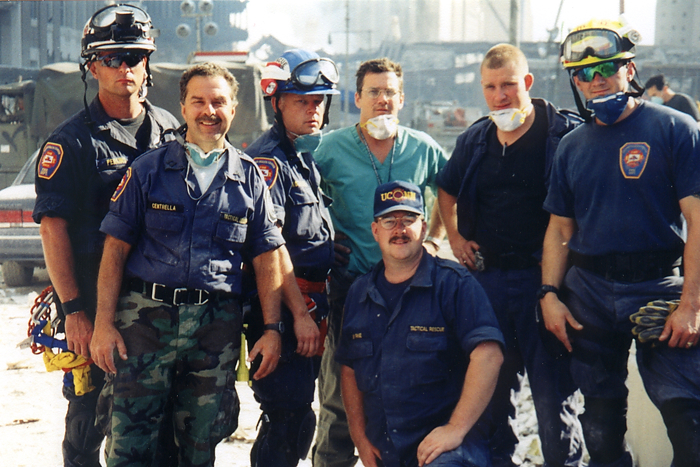Members of the University of Connecticut Health Center Special Operations Unit traveled to New York City in a specially equipped vehicle and were assigned to provide medical support for the New York Urban Search and Rescue Team. They are from left to right: William Perkins, Carmine Centrella, John Kowalski, Robert Fuller, M.D., Greg Priest, Ben Sonstrom, and, kneeling, Daryl Byrne. Fuller is chief of emergency medicine for the Health Center and medical director of the group. The others are all paramedics with the special tactical training.