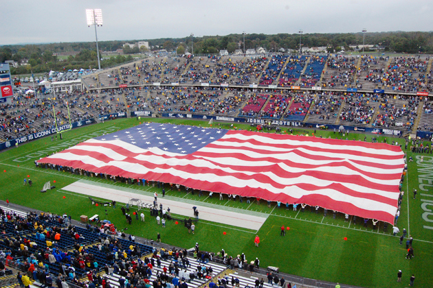 An American flag that covered the playing surface of Rentschler Field was unfurled with the help of 265 volunteers as part of Military Recognition Day before the singing of the National Anthem at the Huskies' game against Western Michigan on Oct. 1.