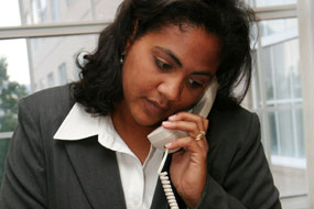 A photo of a business woman talking on the phone.