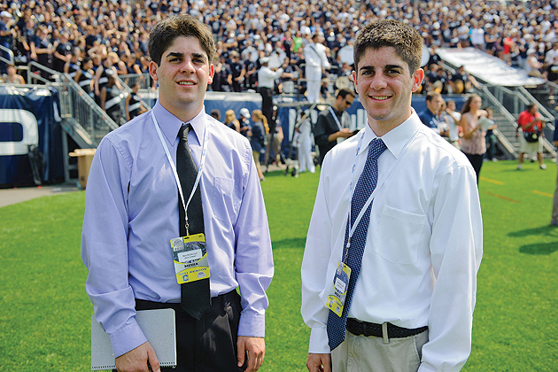 Brothers Matthew McDonough '12 (CLAS), left, and Colin McDonough '12 (CLAS) on the sidelines during a football game at Rentschler Field on September 3, 2011. (Peter Morenus/UConn Photo)