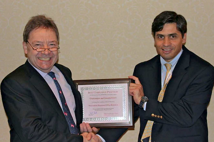 Research compliance monitor Gustavo Fernandez (right) accepts the Best Compliance Practices Award for Monitoring Financial Conflict of Interest in Research on behalf of the UConn Health Center from Dr. Mark Pastin of the Health Ethics Trust on October 25, 2011. (provided by Health Ethics Trust for UConn Health Center)