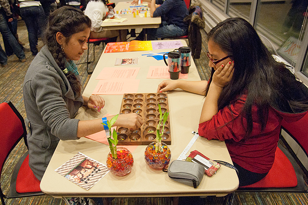 Tsamchoe Dolma '14 and Kriti Thapa '14 play the East African game of Bao at the International Board Game Event at Late Night on Nov. 11, 2011. (Max Sinton/UConn Photo)