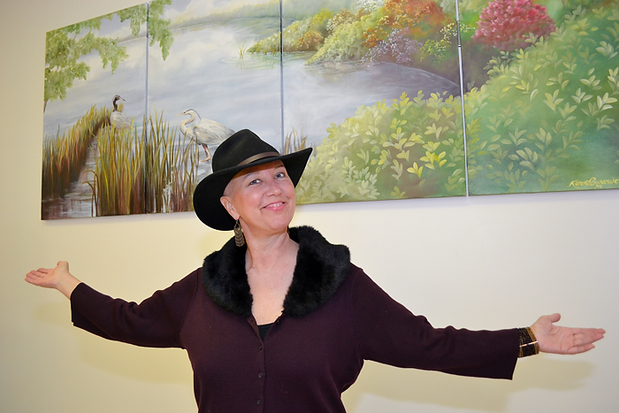 Artist Karen Pergande in front of the mural she painted for the treatment room in the Neag Comprehensive Cancer Center. (Tina Encarnacion/UConn Health Center)