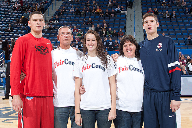 It was a family affair at the XL Center Thursday, when the Olander brothers took the court in the UConn-Fairfield game, which the Huskies won 79-71. Ryan, a senior at Fairfield, scored 8 points and had 8 rebounds, and Tyler '14 (CLAS), a sophomore at UConn, had 2 points and 2 rebounds in the game. The family, who lives in Mansfield, Conn., gathered at center court before the tip-off. From left: Ryan, Skip '70 (ED), Morgan, Tracy, and Tyler. (Steve Slade '89 - SFA)
