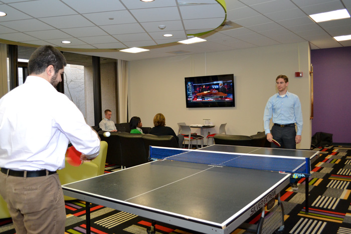 Second-year dental student Sean Ghassem-Zadeh and second-year medical student Ray Lorenzoni play ping-pong in the new Shafer Student Center. (Tina Encarnacion/UConn Health Center Photo)