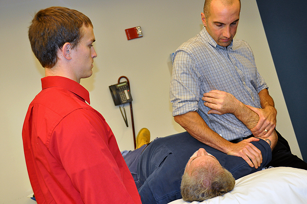 Current DPT Student Gregory Sabo gets hands-on instruction from UConn Health Center physical therapist Gregg Gomlinski as part of his clinical experience. (Shawn Kornegay/UConn Photo)