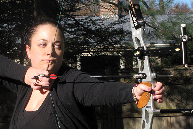 Liz Didan shooting a bow and arrow. (Sheila Foran/UConn Photo)
