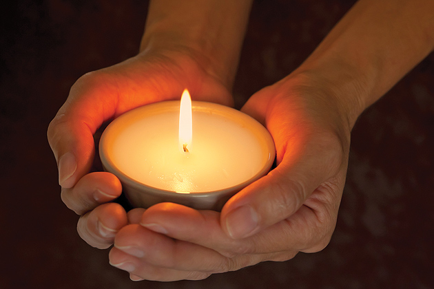 Candle being held in hands