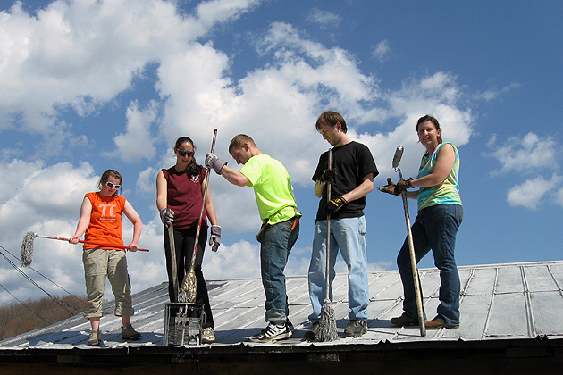 Working under blue skies was a help when it was time to repair the roof. (Photo courtesy of the Honors Program)