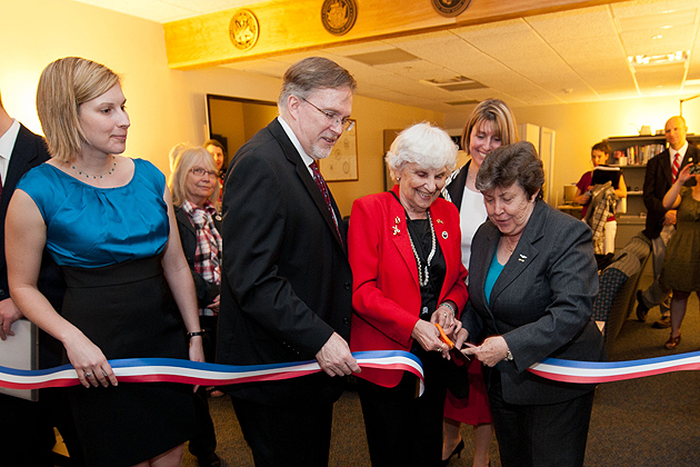 Caitlin Davies, left, '12 (CANR), John Saddlemire, vice president for student affairs, Gloria Hutchinson, federation of Women's Clubs of Connecticut, and Linda Schwartz, commissioner of the department of veterans' affairs, cut the ribbon to open the Student Veterans Oasis at the Student Union on March 21, 2012. (Peter Morenus/UConn Photo)