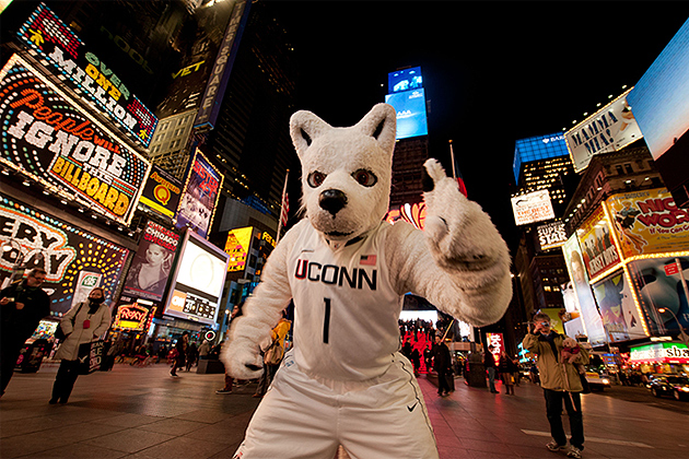 Jonathan the mascot in times square NY at night. (Peter Morenus/UConn Photo)