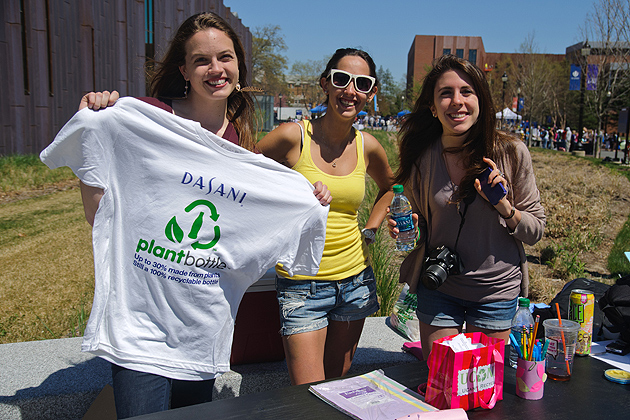 Linda Chadrys, Meg MecCabe, and Jaime Pennella of UCann Recycle take surveys and offer free UCann Recycle gear sponsored by Dasani of Coca-Cola at the UConn Earth Day Spring Fling on April 19, 2012. (Max Sinton for UConn)
