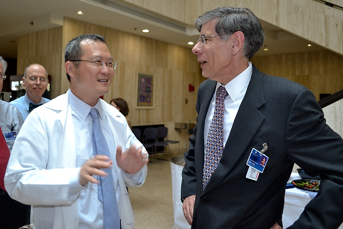 (left to right) Dr. Bruce Liang, head of cardiology who served as interim medical school dean, talks with the Health CenterÕs new executive vice president for health affairs and medical school dean, Dr. Frank Torti, during a welcome reception May 2. (Tina Encarnacion/UConn Health Center Photo)