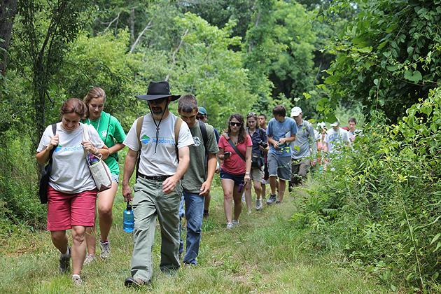John Volin, professor of natural resources and the environment, front right, and extension educator Emily Wilson lead students into the UConn Forest. (Sue Schadt/UConn File Photo)