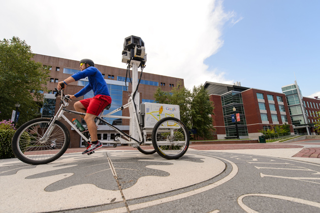 A Google employee takes photos with a tricycle-mounted camera apparatus to improve the Google Street View maps of campus. (Peter Morenus/UConn Photo)