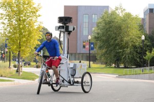 A Google employee takes photos with a tricycle-mounted camera apparatus to improve the Google Street View maps of campus. (Peter Morenus/UConn Photo)