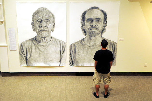 Stephen Quesnel ('14 BUS) observes the faculty art pieces at the Benton on Sept.5, 2012. (Max Sinton '15 (CANR)/UConn Photo)