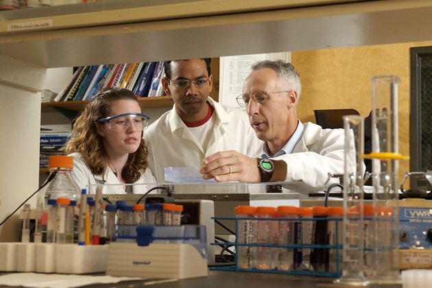 David Grant, right, associate professor of pharmaceutical science, with students, in his lab.