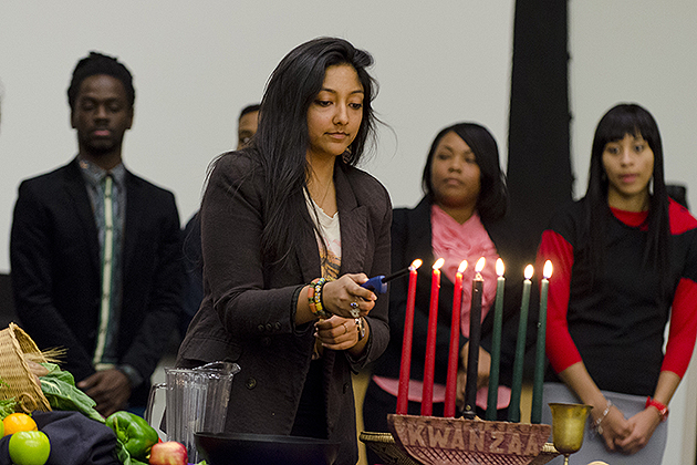 Students light candles at the annual Kwanzaa Observance Dinner in the Student Union Ballroom on Dec. 7. (Ariel Dowski '14 (CLAS)/UConn Photo)