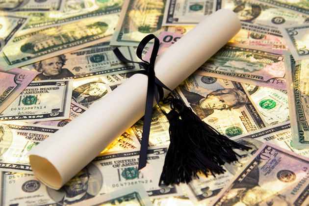 Diploma wrapped in black ribbon on top of money.