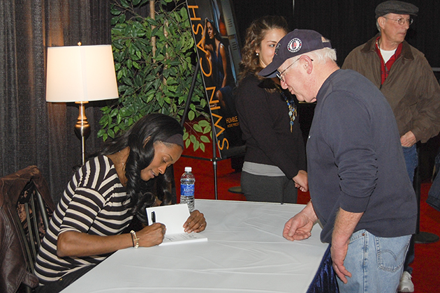 Swin Cash '02 (CLAS) signed copies of her book at the XL Center during the Big East Women's Basketball Tournament. (Ken Best/UConn Photo)