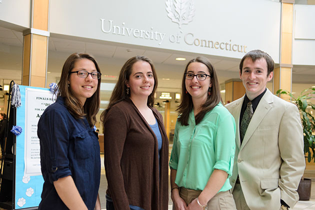 From left, Emily Funk '13 (CLAS), Anna Green '13 (CLAS), Jennifer Bento, a Ph.D. candidate in the polymer program in the Institute of Materials Science, and Tyler Reese '13 (CLAS), in the Wilbur Cross Building. (Ariel Dowski '14 (CLAS)/UConn Photo)