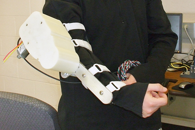Brian Coleman'13 (ENG) developed a robotic arm that can be used by astronauts to prevent muscle loss in zero gravity. (Cathleen Torrisi/UConn photo)