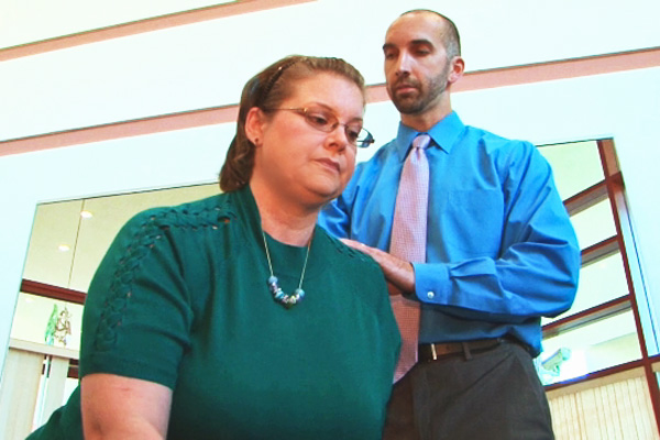 Patient Kim Ireland with physical therapist Greg Gomlinski. (Screen capture from video by Frank Barton)