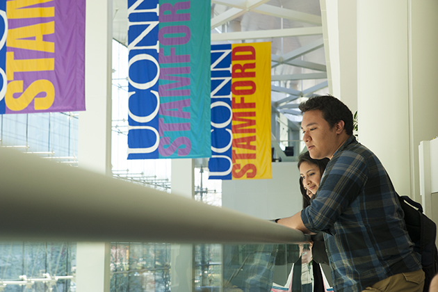Students watching a performance at the Stamford Campus with banners in the background on April 25, 2013. (Sean Flynn/UConn Photo)