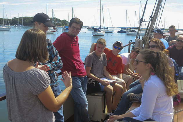 Helen Rozwadowski, left, associate professor of history and maritime studies at the Avery Point campus, explains to students on board the Mystic Whaler what the class will cover. (Nathaniel Trumbull/UConn Photo)