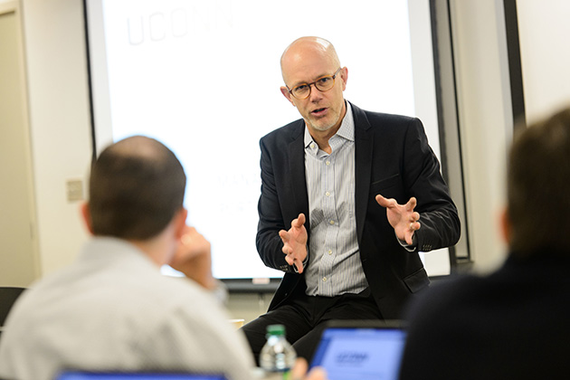Timothy Folta, professor of management, leads a class at the Graduate Business Learning Center in Hartford. (Peter Morenus/UConn File Photo)