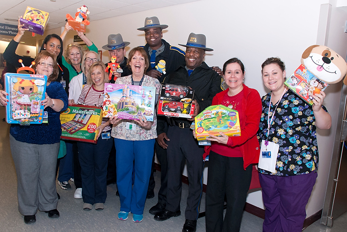 Connecticut state troopers delivered dozens of toys Wednesday to siblings of babies in the neonatal intensive care unit at the Health Center on December 18, 2013. (Janine Gelineau/UConn Health Center Photo)