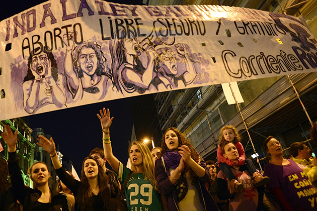 Demonstrators react under a banner during a demonstration against the Spanish government's controversial bid to curb abortion rights in central Madrid to mark International Women's Day on March 8, 2014. The annual women's rights day drew particular attention this year with women's rights groups defending their labour rights as the Spain struggles with a 26-percent unemployment rate despite technically exiting recession last year. AFP PHOTO/ JAVIER SORIANO (Photo credit should read JAVIER SORIANO/AFP/Getty Images)