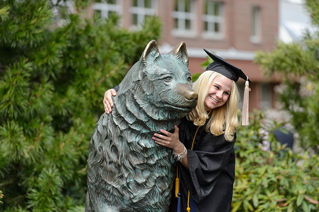 Chelsea McCallum of Somers poses for a photo with Jonathan statue following the School of Business commencement ceremony at Harry A. Gampel Pavilion on May 12, 2013. (Peter Morenus/UConn Photo)