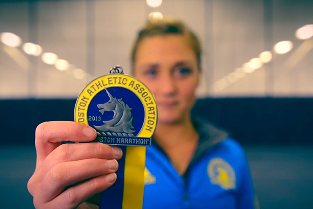 Kali Cika '15 displays the medal she earned for running the Boston Marathon in 2013. She was fortunate to complete her run before the bombs went off. (Angie Reyes/UConn Photo)