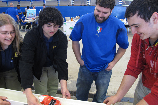 The team from Wolcott Technical High School in Torrington and their mentor, GK-12 Fellow Joe Parisi (center) find success with their modified boat. (William Weir/UConn Photo)