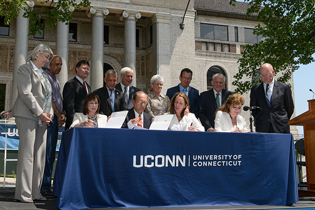 President Susan Herbst signs paperwork with representatives of the HB Nitkin Group, the state Office of Policy and Management, and the Capital Region Development Authority at an event to formalize plans establishing a new UConn campus in downtown Hartford on June 3, 2014. (Peter Morenus/UConn Photo)