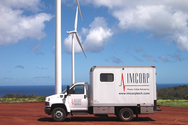 An IMCORP van in front of wind turbines in Hawaii. (Photo supplied by IMCORP)