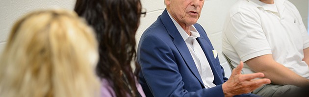 Alex Gitterman, professor of social work, meets with graduate students at the School of Social Work on Aug. 28, 2014. (Peter Morenus/UConn Photo)