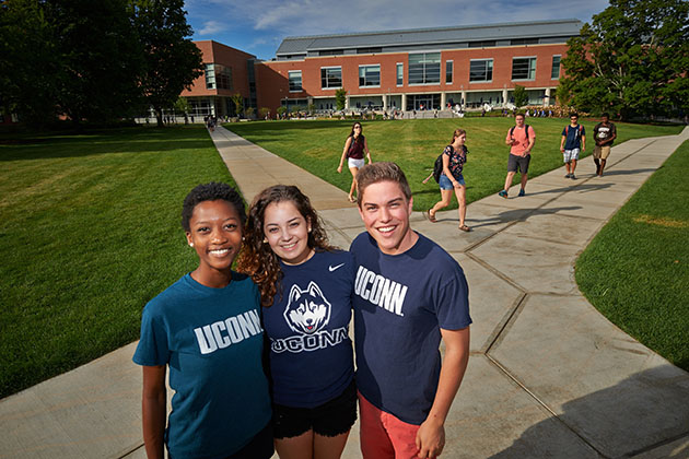 Student wearing UConn apparel pose for photos on the Student Union Mall on Sept. 3, 2014. (Peter Morenus/UConn Photo)