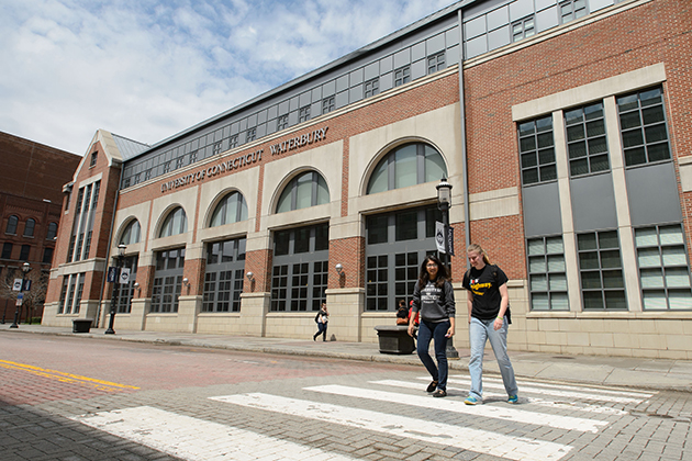 Students cross the street outside the Waterbury campus on May 1, 2014. (Peter Morenus/UConn Photo)